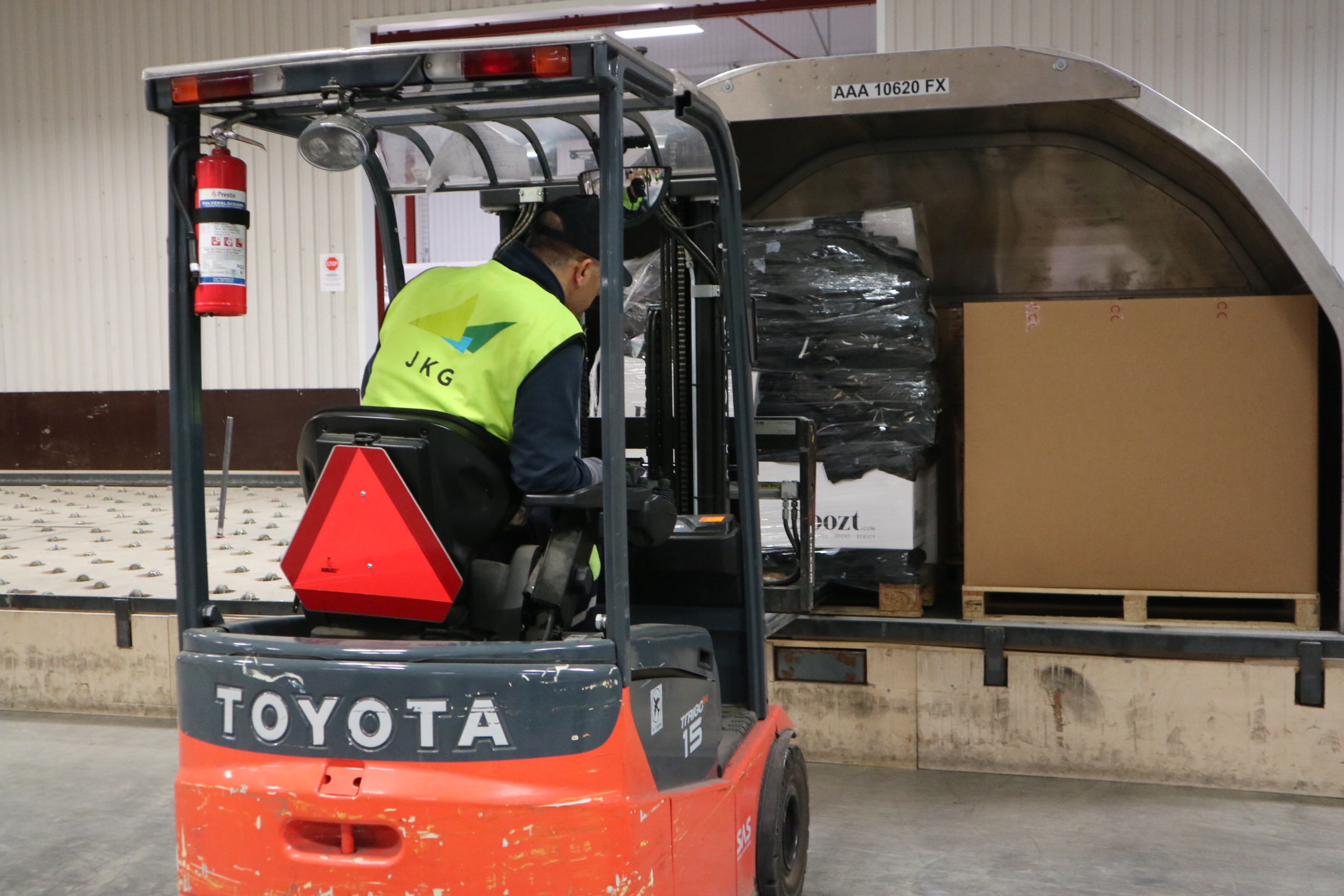 Employees move goods by truck in the freight terminal