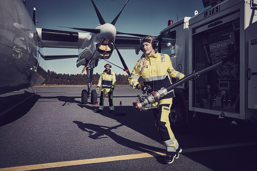 Female employee about to refuel propeller aircraft